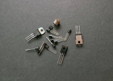 Bazı transistör tipler. Yumuşak siyah arkaplanda yarı iletken bileşenleri.