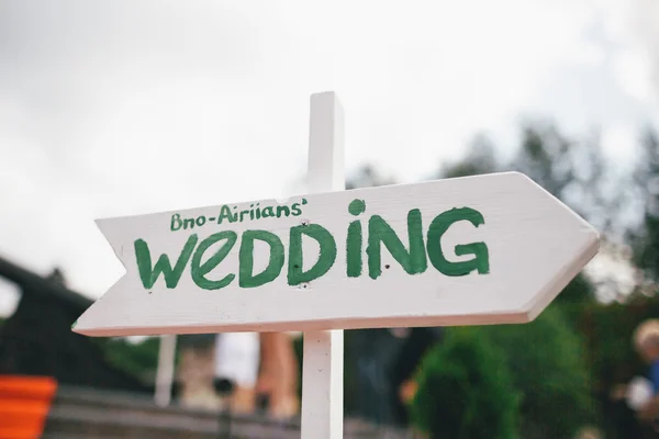 wooden sign with word wedding on it