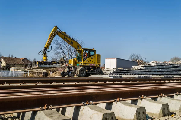 Novi Sad, Serbia - March 02. 2021: Working machine, double excavator - Vaia Car V804FS, on the railway line in Petrovaranin, Novi Sad, Serbia