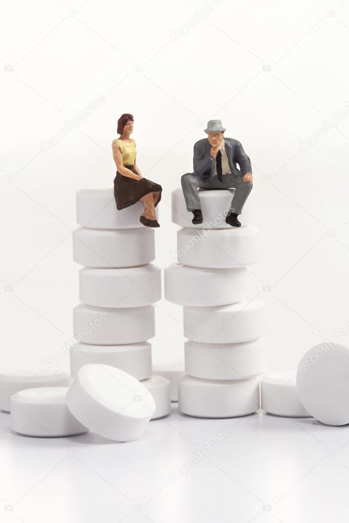 miniature people - people posing in front of pills