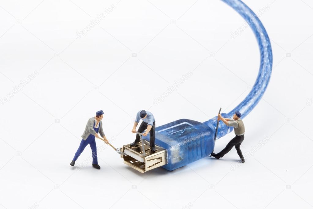 miniature people  - workers fixing a USB plug