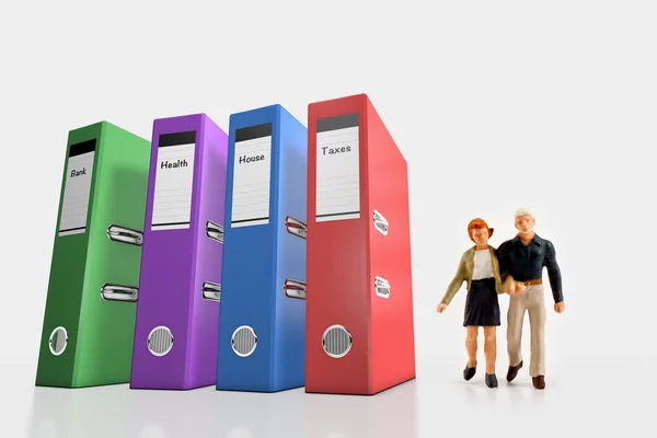 Miniature people  - a couple standing near of their invoices folders — Stock Photo, Image