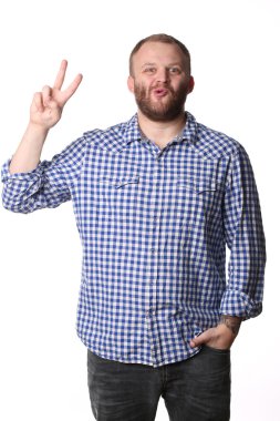 Smiling man with a beard showing hand peace sign