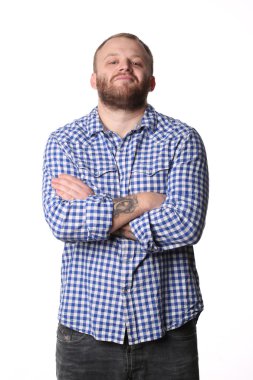 Smiling man with beard standing arms crossed looking at camera