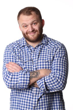 Smiling man with beard standing arms crossed looking at camera