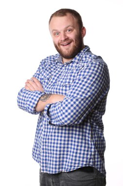 Smiling man with beard standing arms crossed looking at camera