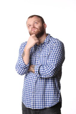 Pensive man with beard standing arms crossed looks into distance