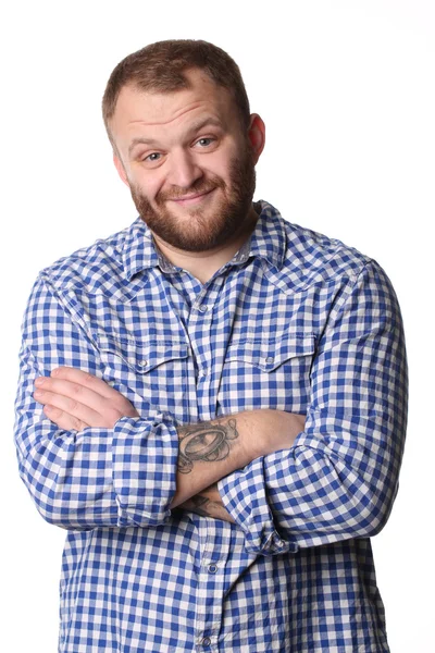 Smiling man with beard standing arms crossed looking at camera