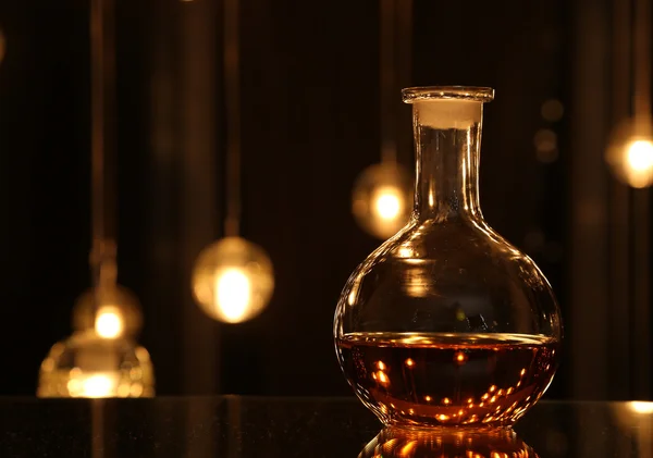 Bottle with drink against blur bokeh light. Horizontal photo — Stock Photo, Image