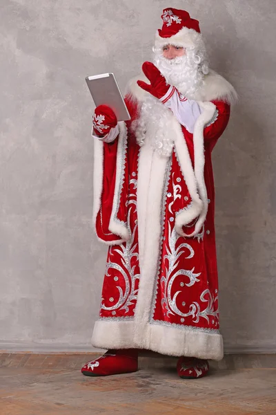 Father Frost looking at the tablet — Stock Photo, Image