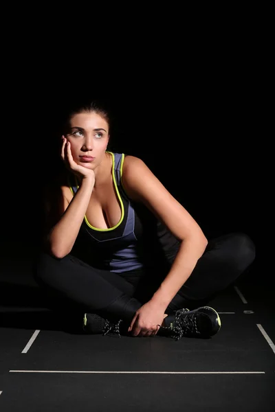 Söt ung Fitness kvinna sitter med vikta ben — Stockfoto