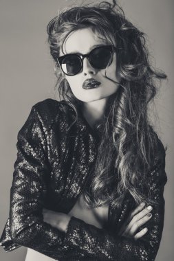 Portrait of stylish brunette female model in sunglasses
