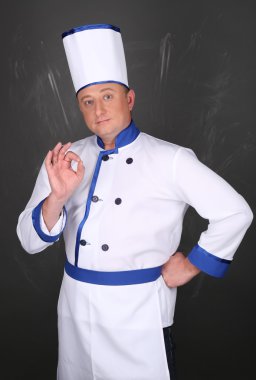 Portrait of chef and hand doing gesture is all right