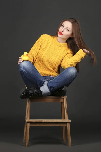 Genuine brunette woman in a yellow jacket with red lips — Stock Photo, Image