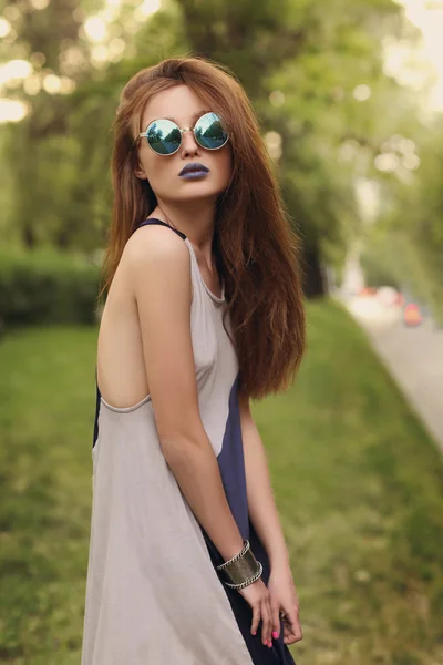 Schöne brünette Mädchen mit blauen Lippen in runden Sonnenbrillen — Stockfoto