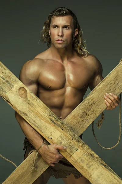 Men with perfect muscular naked torso, holding hands wooden beams — Stock Photo, Image