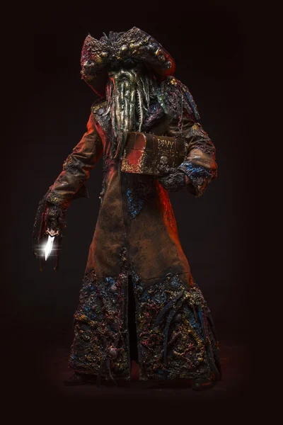 Man dressed in costume monster, octopus mask, beard of tentacles.