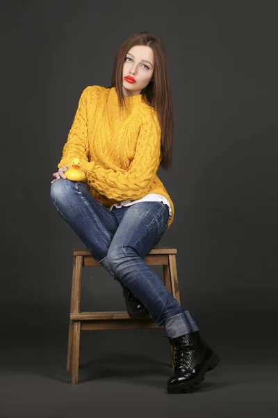 Genuine brunette woman in a yellow jacket with red lips — Stock Photo, Image