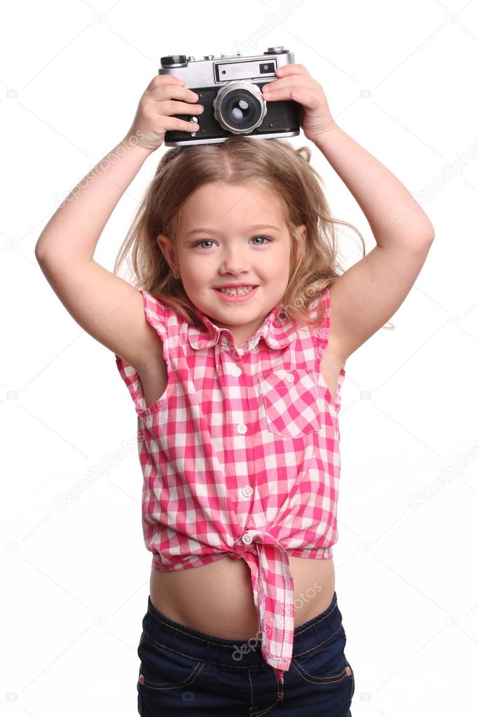 Child posing with a camera. Close up. White background