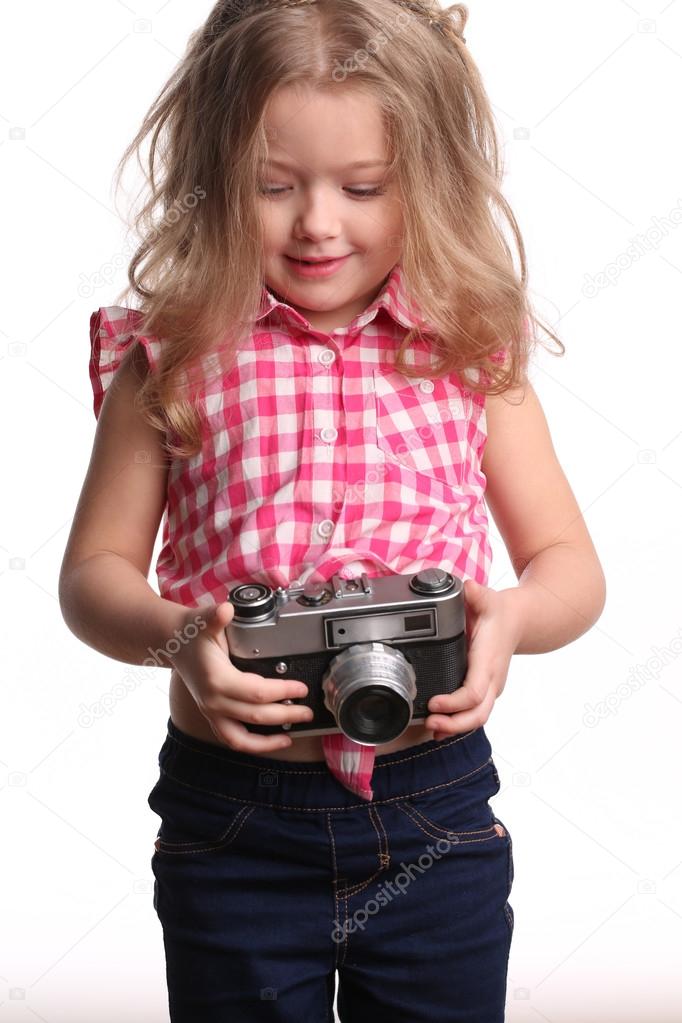 Child girl with camera. Close up. White background