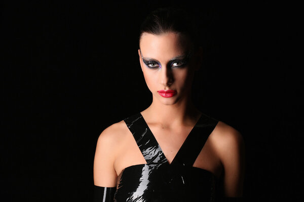 Girl with adhesive tape on her body. Close up. Black background