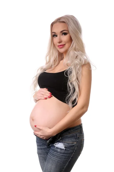 Una mujer embarazada. De cerca. Fondo blanco — Foto de Stock