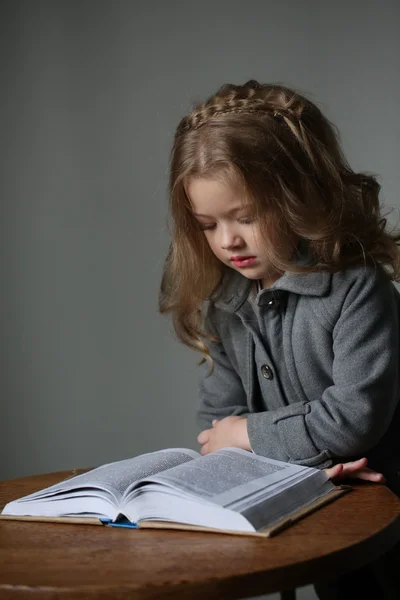 Dziecko dziewczyna czytania książki. Z bliska. Szare tło — Zdjęcie stockowe