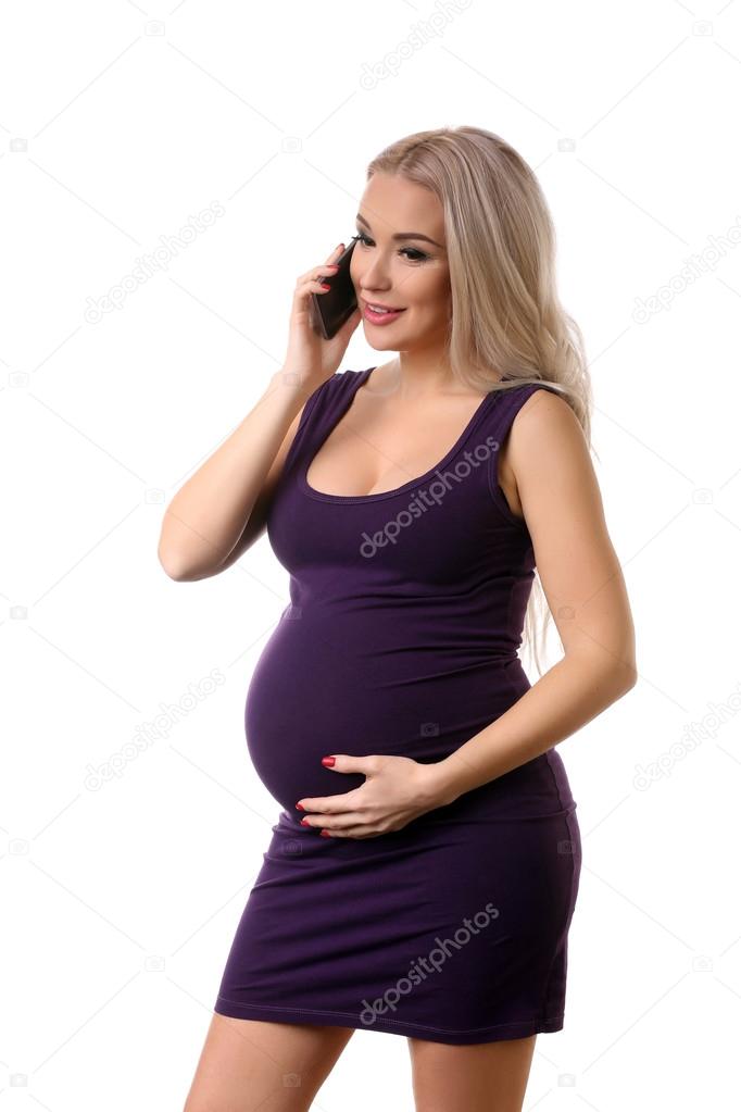 Pregnant woman in dress talking on the phone. Close up. White background