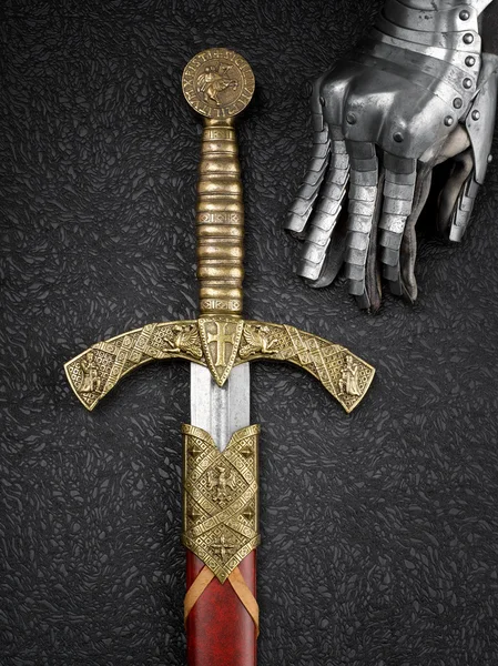 Knight's gloves and sword. — Stock Photo, Image