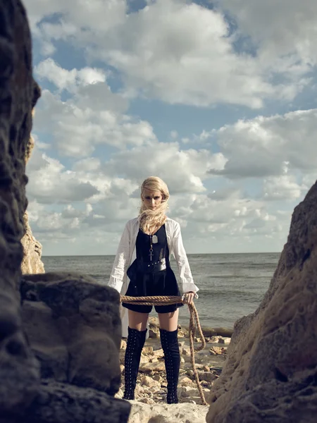 Mulher pirata bonita de pé na praia de botas . — Fotografia de Stock