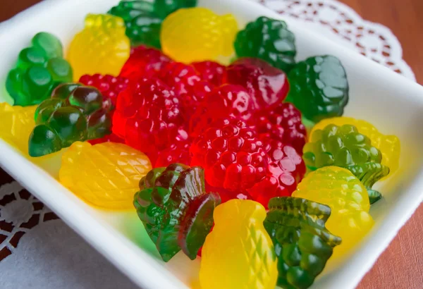 Colourful fruit jelly candies on a white plate — Stock Photo, Image