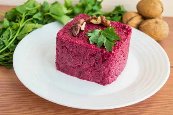 Vitamin salad of boiled beets in the form of a square, with walnuts on a white plate — Stock Photo, Image