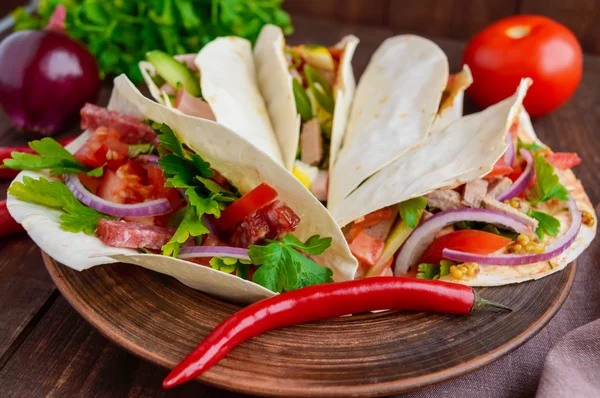 East pita bread with various fillings (meat, salami, egg, cucumber, parsley, tomato, chili pepper, Dijon mustard). — Stock Photo, Image