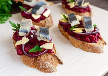 Etsiz diyet sandviç: haşlanmış beetroots, mor soğan, tuzlanmış ringa balığı ve pul gevrek bir baget üzerinde füme peynir.