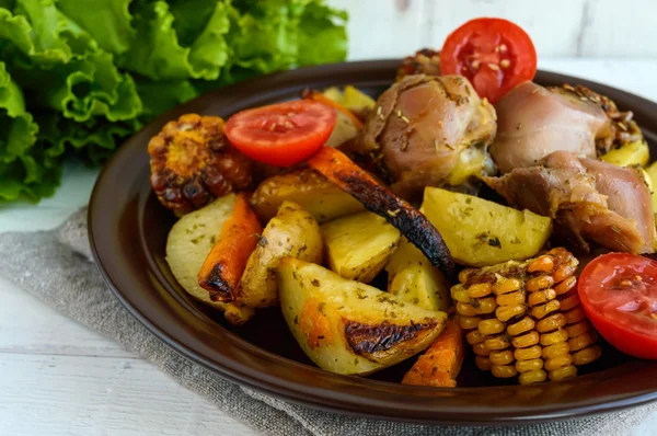 Запечена картопля зі шматочками смаженої гуски, овочами та кукурудзяним грилем — стокове фото