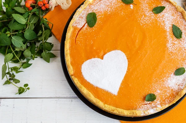 Sweet pumpkin pie on a white background. The top view. Dietary vegan dish. Traditional baked for Thanksgiving.