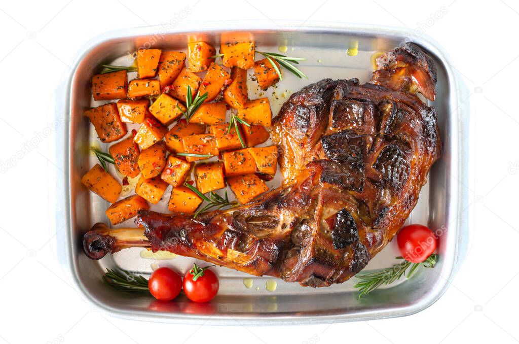 Baked turkey leg, pumpkin slices with spices in a container isolated on a white background. Thanksgiving Day. Meat dish. Top view.