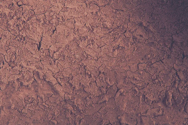 干ばつで干上がった土地の質感 地面の亀裂の背景 — ストック写真