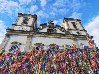 Bonfim Church facade with colored ribbons on the grid clipart