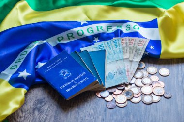 Brezilya belgesi ve sosyal güvenlik belgesi ve Brezilya bayrağı üzerine Brezilya para birimi.