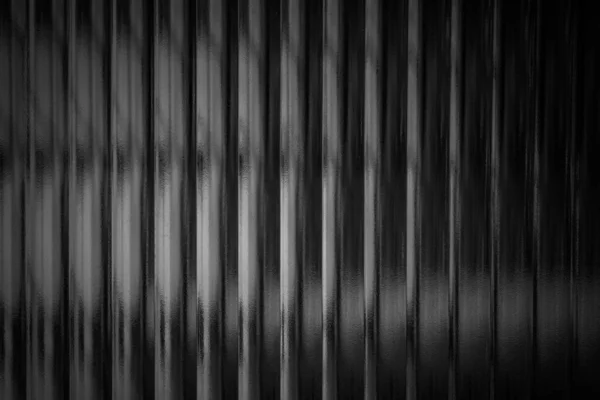 Black background with vertical lines and texture.