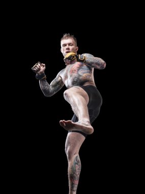 Yüksek tekme siyah arka plan üzerine hazırlanan güçlü mma savaşçı
