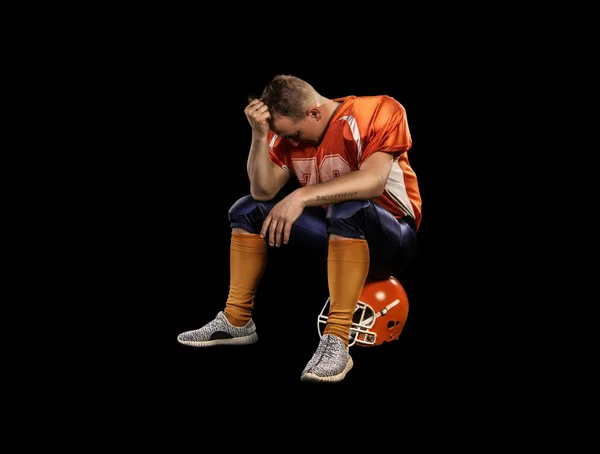 American football player sitting on helmet isolated — Stock Photo, Image