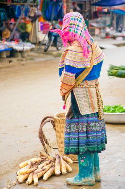 Woman of the Flower H'mong Ethnic Minority People at market in Bac Ha, Vietnam. H'mong are the 8th largest ethnic group in Vietnam. clipart