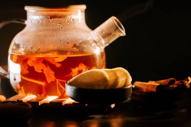 Warm black tea with lemon slices in a cozy setting during the evening
