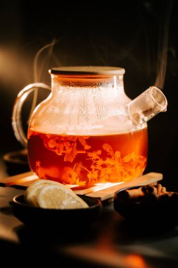 Warm black tea brewed with herbs and served with fresh lemon slices