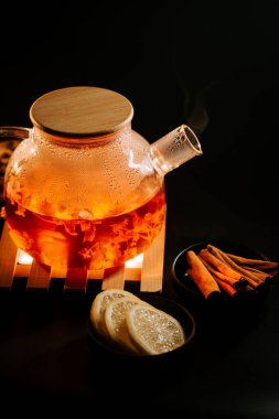 Warm black tea with lemon and spices served in a cozy setting