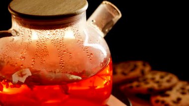 Enjoying a warm cup of black tea with freshly baked cookies at home