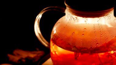 Perfectly brewed black tea in a glass teapot on a cozy evening