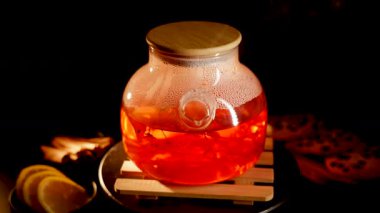 Brewing black tea with spices and cookies in a warm, cozy setting
